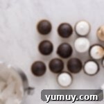 A kitchen torch delicately toasting the marshmallow meringue on top of chocolate cupcakes, creating a golden-brown finish.