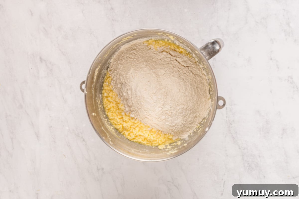 Cake mix with cupcake batter in a mixing bowl.