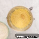 a bowl of flour and yellow substance.