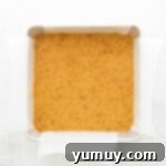 Luscious Strawberry Cheesecake Bars 6 Strawberry cheesecake bars crust firmly pressed into a square baking pan, forming an even layer.