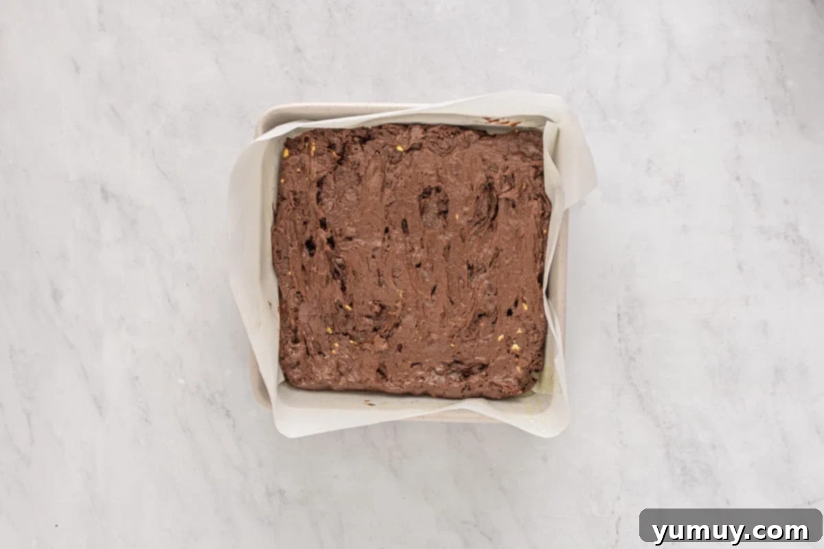 Emerald Fudge Brownies 15 avocado brownie batter spread into a square baking pan.