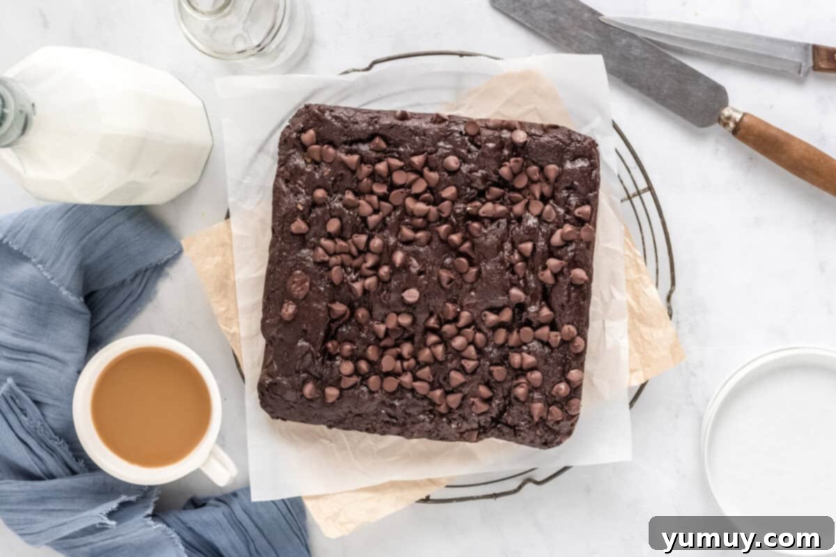 Emerald Fudge Brownies 3 overhead view of avocado brownies on parchment paper on a round cooling rack.