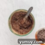 Emerald Fudge Brownies 7 avocado brownie batter in a green bowl with a whisk.