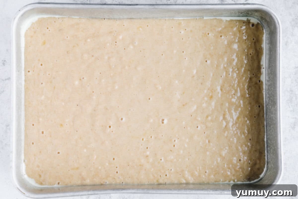 banana cake batter poured into a sheet pan.