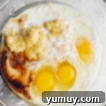 overhead view of wet ingredients for banana cake in a glass bowl.