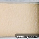 banana cake batter poured into a rectangular baking pan.