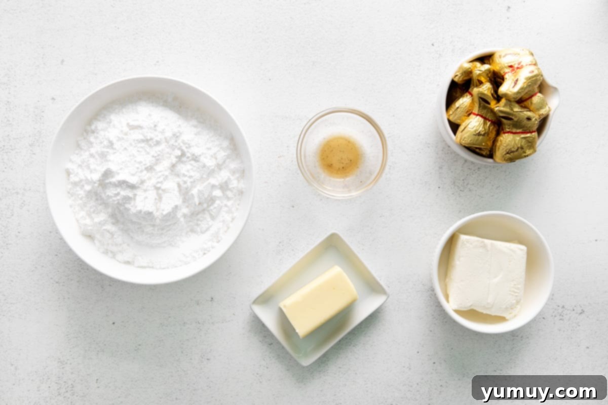 An overhead view of softened butter and cream cheese in a mixing bowl, ready to be beaten for the frosting.