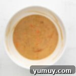 Easter bunny cupcake batter being mixed in a white bowl, showing a smooth consistency.