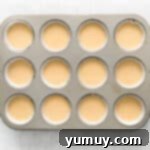 easter cupcake batter in the wells of a cupcake tin.