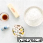 overhead view of ingredients for frosting for easter cupcakes in individual bowls.