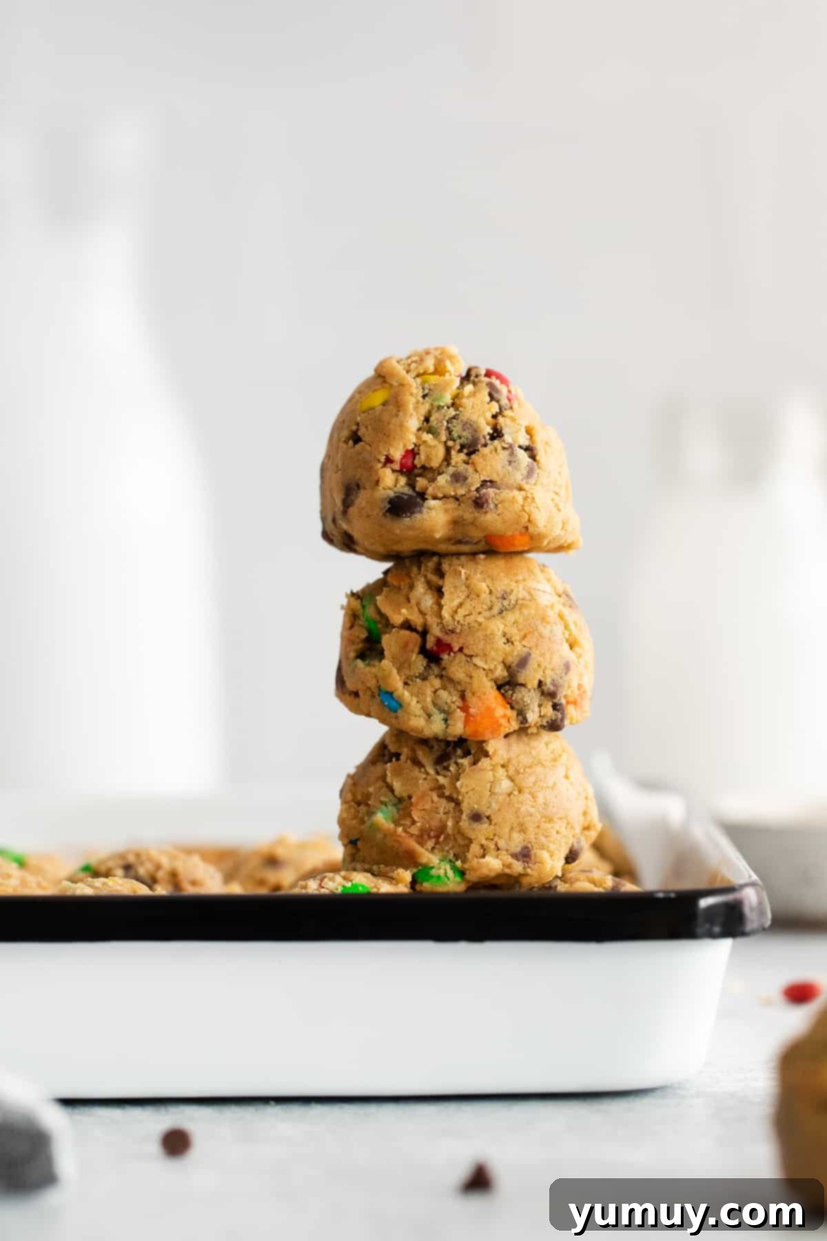 No-Bake Monster Cookie Dough 3 Stacked balls of colorful edible cookie dough, ready to be enjoyed as a delightful snack.