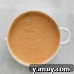 Pancake batter with a few small lumps after mixing wet and dry ingredients.