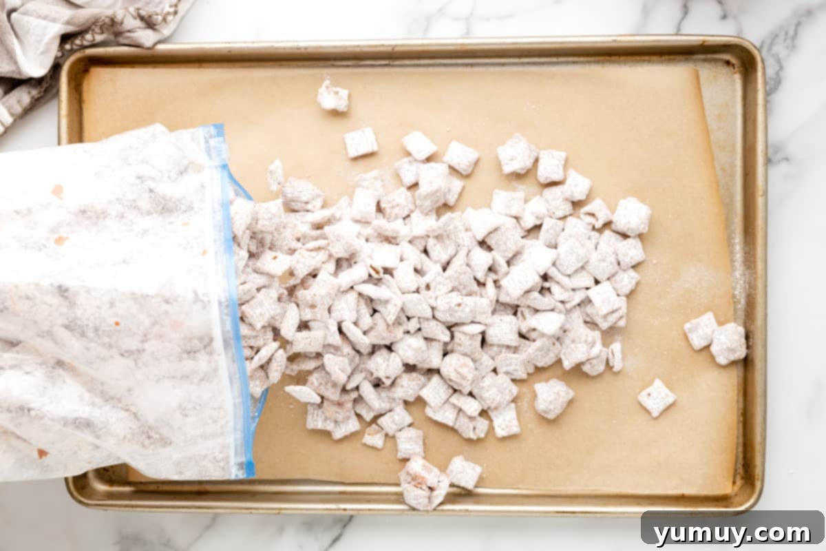 Campfire Crunch Bites 13 sugar-coated Chex cereal poured out of a ziplock bag onto a lined baking sheet to set.