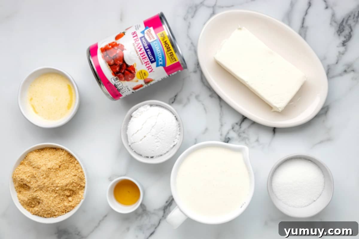 All the essential ingredients for no-bake strawberry cheesecake cups arranged on a marble table, ready for preparation.