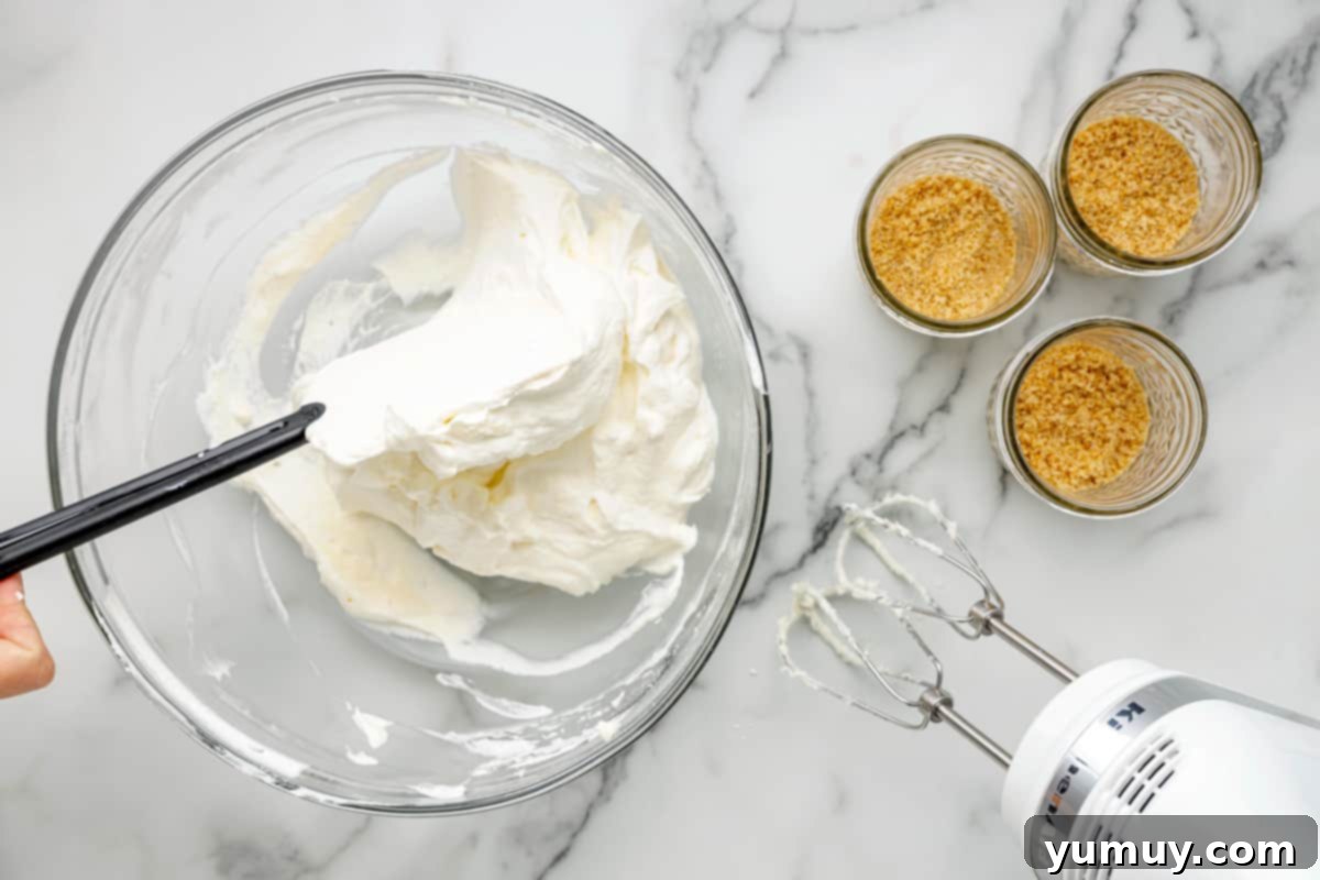 A gentle folding motion combining whipped cream into the cream cheese mixture, ensuring a light and airy consistency.