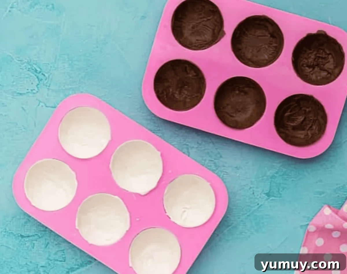 melted chocolate in half sphere molds.