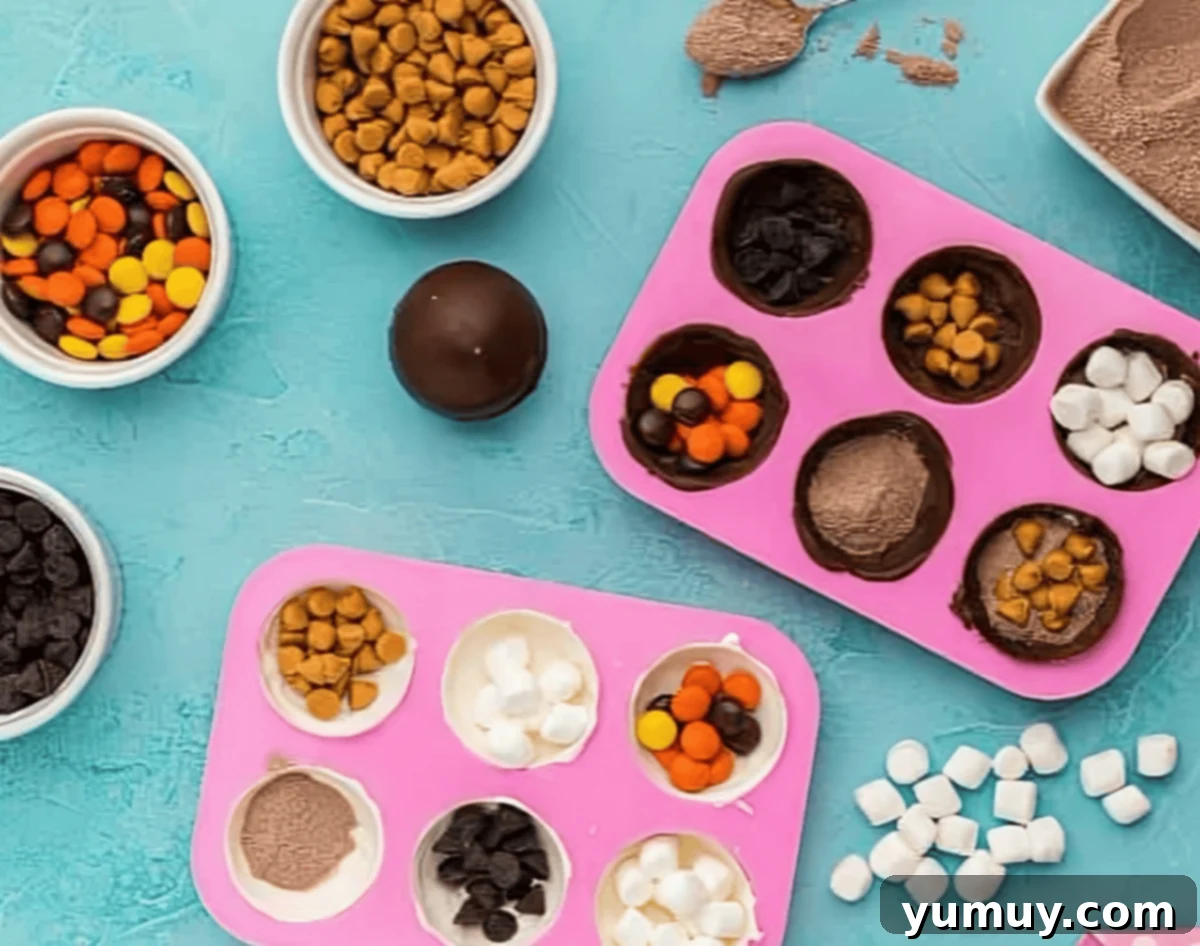 chocolate half sphere molds filled with hot cocoa mix and candy.