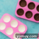 melted chocolate in half sphere molds.