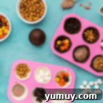 chocolate half sphere molds filled with hot cocoa mix and candy.