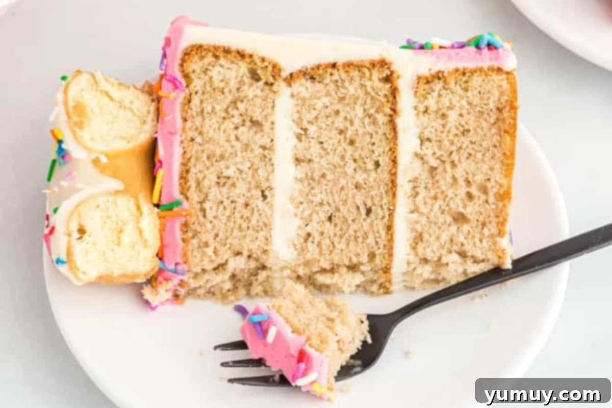 a partially eaten slice of donut cake on a plate with a fork.