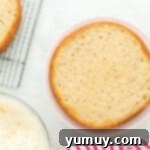 a leveled layer of donut cake on a cake stand.