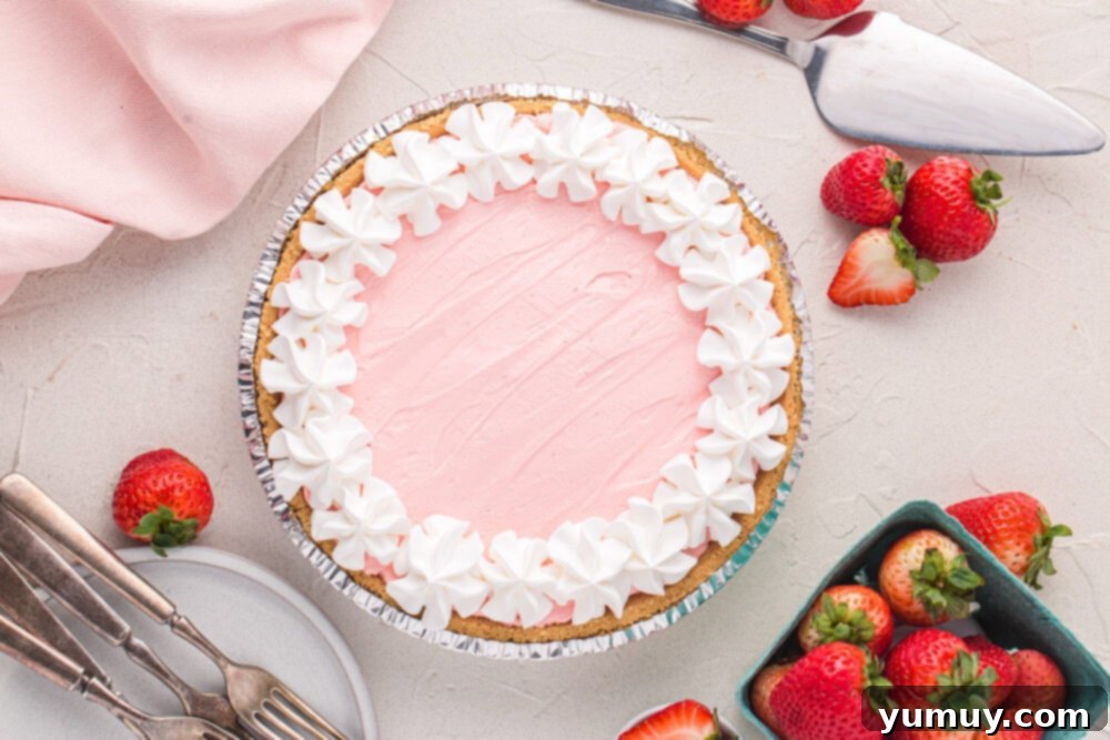 overhead view of kool aid pie in a disposable aluminum pie dish with cool whip topping.