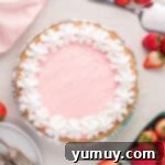 overhead view of kool aid pie in a disposable aluminum pie dish with cool whip topping.