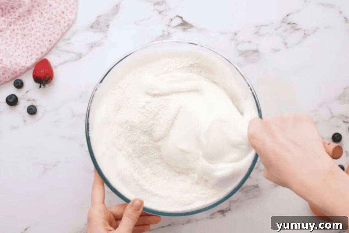 Airy Dream Cake 14 folding flour into beaten egg whites with a rubber spatula.
