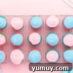 overhead view of 15 cotton candy cupcakes on a wire cooling rack.