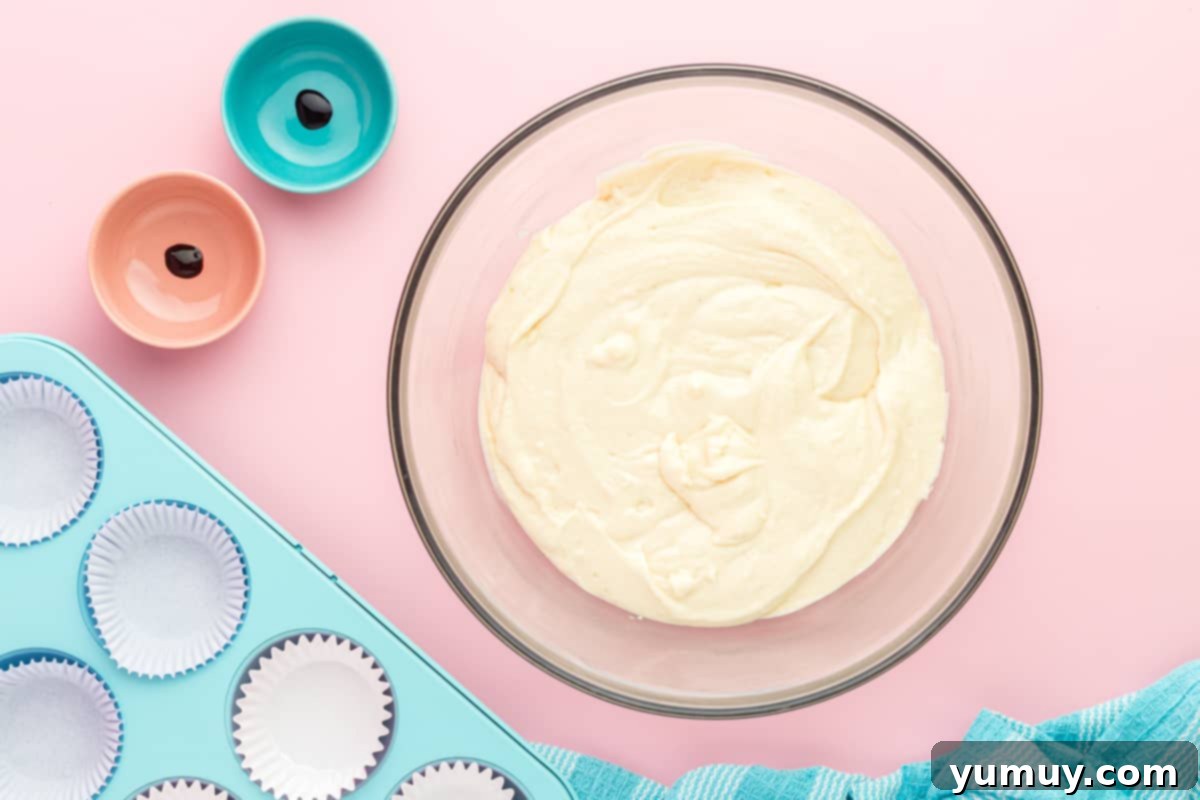 cotton candy cupcake batter in a glass bowl.