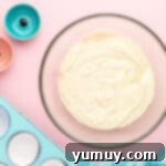 cotton candy cupcake batter in a glass bowl.