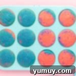 overhead view of baked cotton candy cupcakes in a cupcake tin.