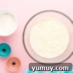 overhead view of frosting for cotton candy cupcakes in a white bowl.