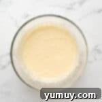 Bursting Blueberry Bundt 9 Wet ingredients for blueberry bundt cake in a glass bowl after sour cream addition.