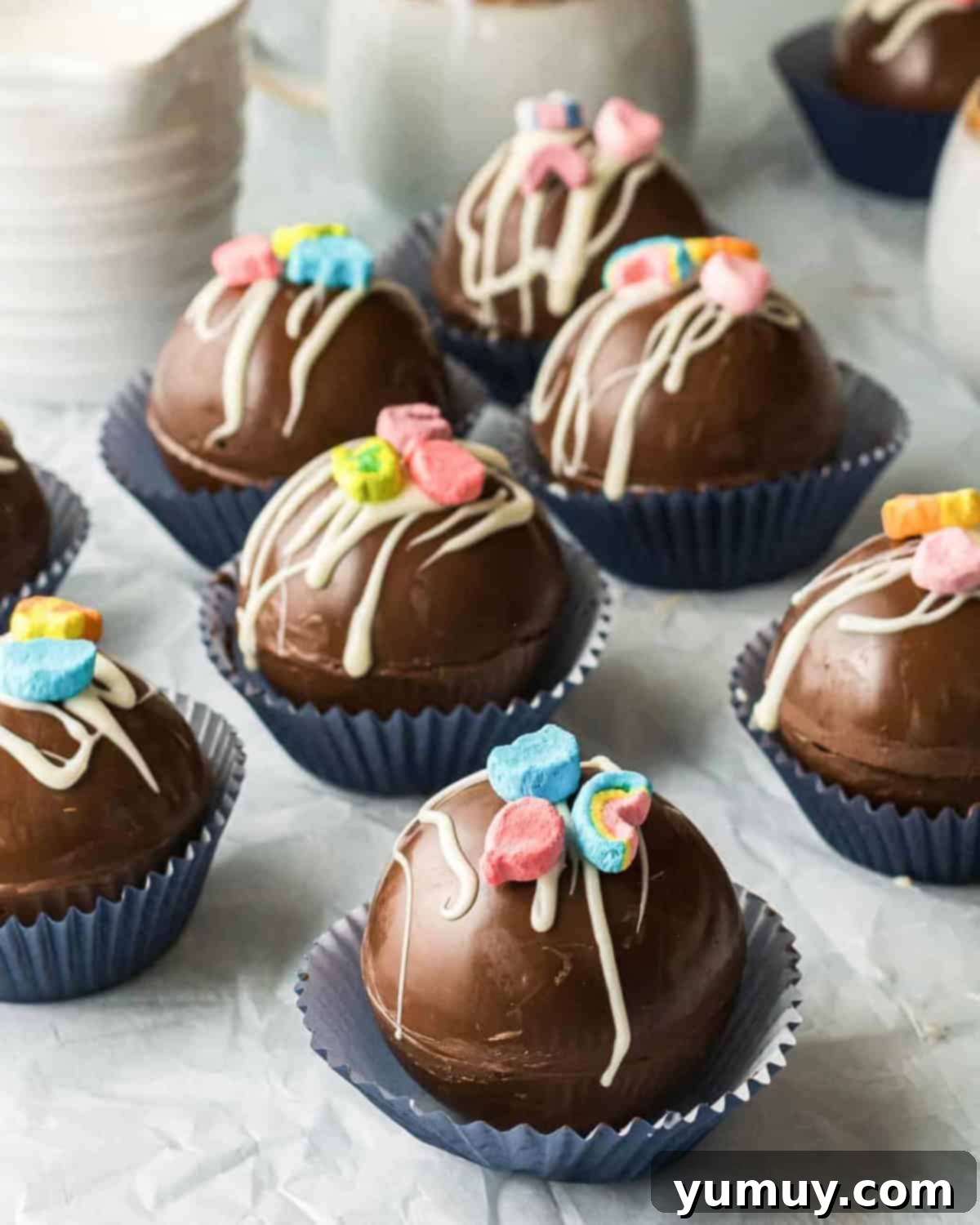 Magical Lucky Charms Hot Cocoa Bombs 2 Lucky Charms hot chocolate bombs neatly arranged in blue cupcake wrappers, showcasing their colorful marshmallow topping.