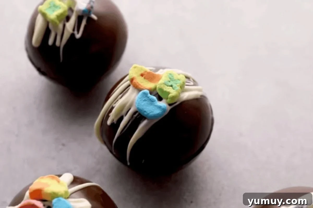 Magical Lucky Charms Hot Cocoa Bombs 15 Finished Lucky Charms hot chocolate bombs, drizzled with white chocolate and topped with marshmallows.