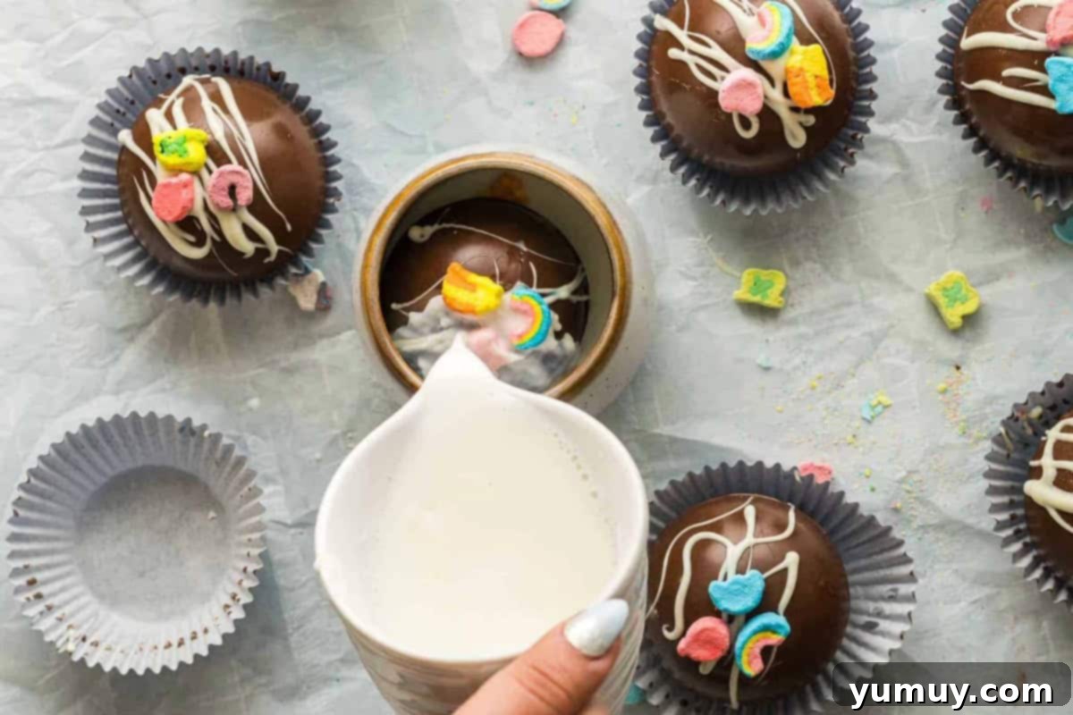Magical Lucky Charms Hot Cocoa Bombs 16 Hot milk is poured over a Lucky Charms hot chocolate bomb in a mug, causing it to melt and release its contents.