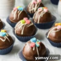 Magical Lucky Charms Hot Cocoa Bombs 4 Lucky Charms hot chocolate bombs in blue cupcake wrappers, ready to be enjoyed.