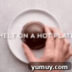 Magical Lucky Charms Hot Cocoa Bombs 8 The edges of a chocolate half-sphere are melted on a warm plate to prepare for sealing.