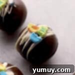 Magical Lucky Charms Hot Cocoa Bombs 9 Finished Lucky Charms hot chocolate bombs, drizzled with white chocolate and topped with marshmallows.