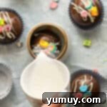 Magical Lucky Charms Hot Cocoa Bombs 10 Hot milk is poured over a Lucky Charms hot chocolate bomb in a mug, causing it to melt and release its contents.