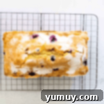 glazed lemon blueberry pound cake on a wire rack.