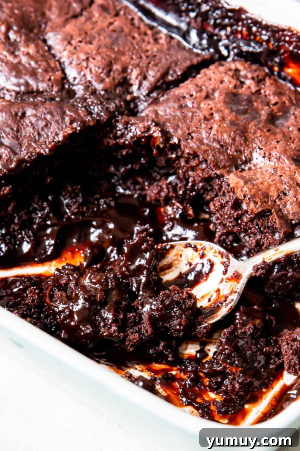 spoon in pan of chocolate cobbler