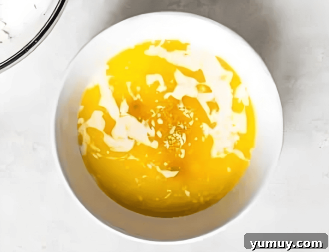 melted butter and milk in a white bowl.