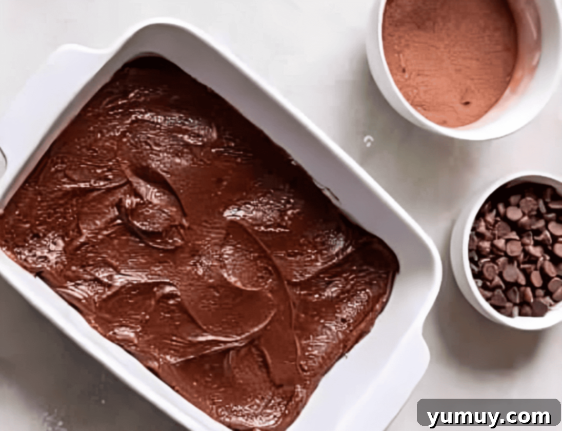 chocolate cobbler batter in a baking dish.