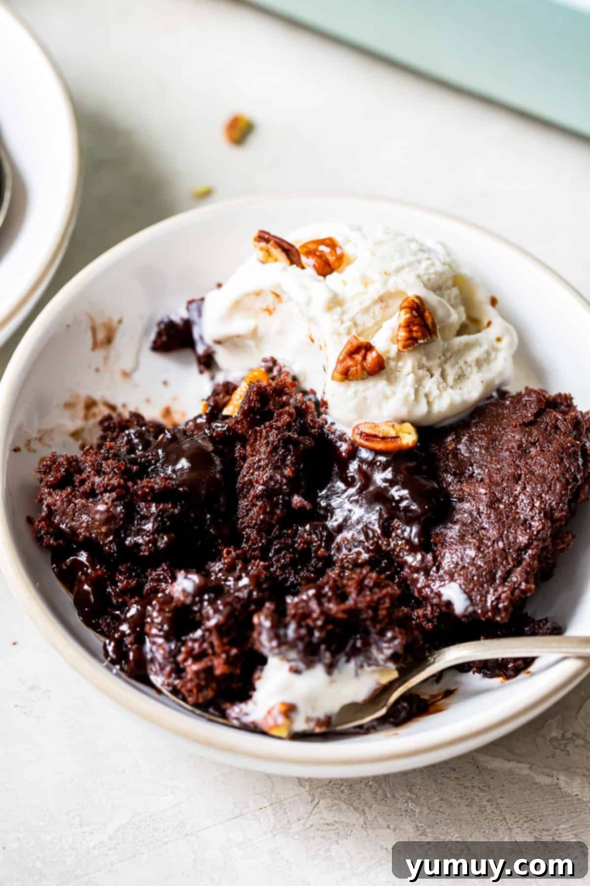 up close bowl of chocolate cobbler with vanilla ice cream