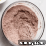 dry chocolate cake mix in a glass bowl with a whisk.