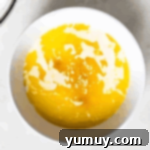 melted butter and milk in a white bowl.