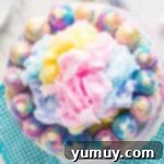 overhead view of frosted cotton candy cake with cotton candy on top.