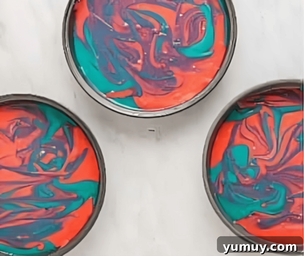 swirled pink and blue cake batter in a round cake pan.
